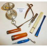 Amber and silver cigar or cheroot holders, other cigarette holders, a compass, a silver and