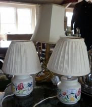 Pair of Poole Pottery table lamps and a brass Corinthian column table lamp