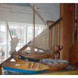 Scale wooden models of a Chinese sailing junk, a sampan and a wooden model of a Riva speedboat