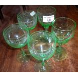 Three etched uranium glass wine glasses and a similar pair of wine glasses