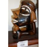 Modern Oceanic tribal art carved hardwood figure of two heads with mother of pearl inlaid eyes and