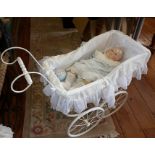 Composition head doll in a vintage white metal doll's pram