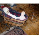 Vintage wickerwork child's dolls carriage on four wheels with hood and lined with tartan fabric.