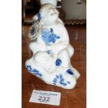 Chinese blue and white porcelain figure of a seated girl figure with flower