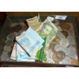 Tin of old coins and banknotes