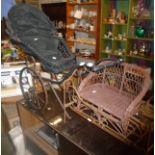 Continental wicker and metal dolls pushchair on two wheels. Together with a wrought iron doll's