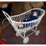 Painted basketware dolls carriage with three various dolls