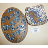 Two Arts & Crafts style copper and enamel plaques depicting stylised fish and a seahorse, in the