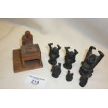 Chinese small wood carving of a scholar seated at a table and six small bronze Buddhas