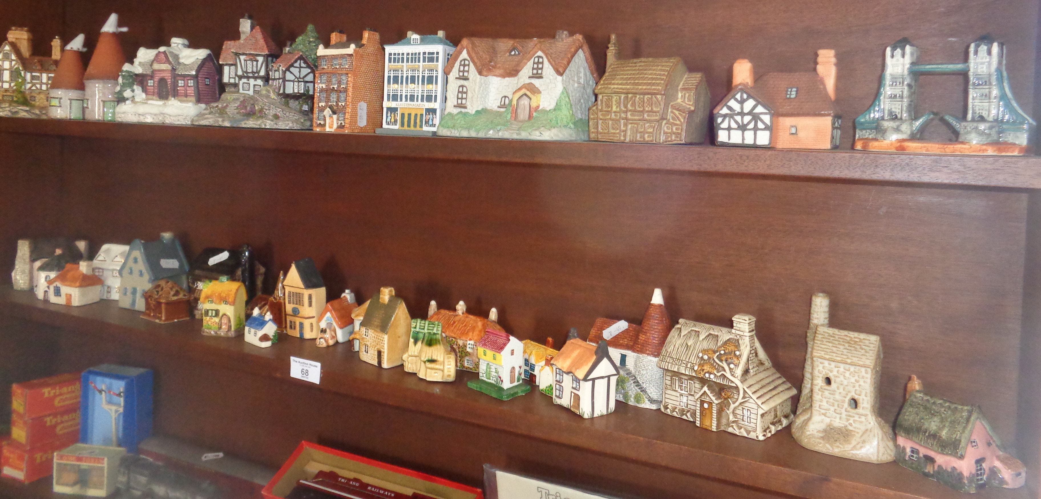 Collection of assorted resin and pottery cottages (two shelves)