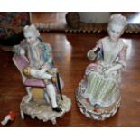 Continental porcelain pair of figurines (one A/F) of a young seated couple, crossed swords mark in