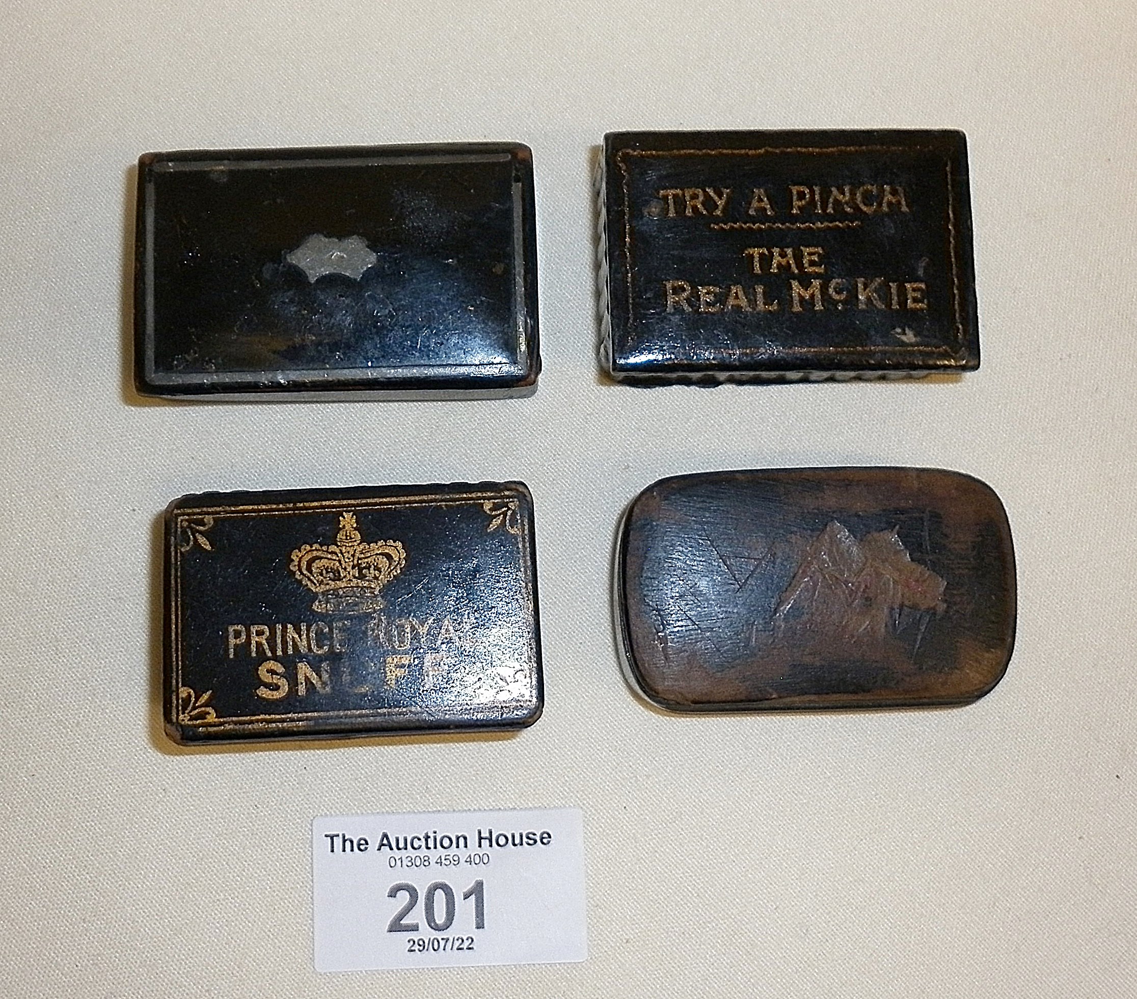 Four various antique lacquered papier mache snuff boxes, one reading "Prince Royal Snuff" and