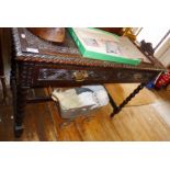 Victorian carved oak writing table with two drawers under