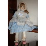 A Victorian poured wax doll having head, shoulders, arms and legs, with blonde wig