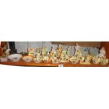 Collection of Lucky White Heather souvenir china ornaments (one shelf)