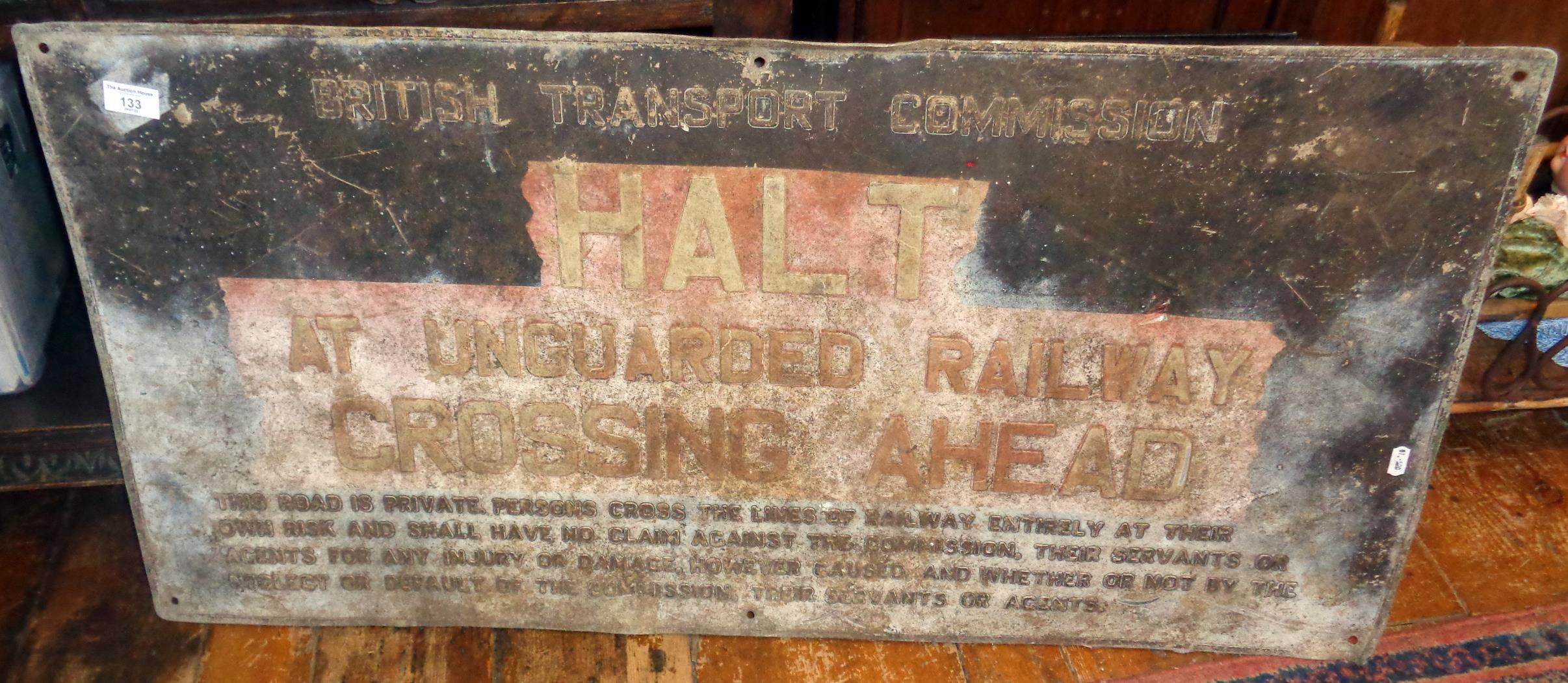 Railway crossing sign for British Transport Commission. "HALT at unguarded railway crossing ahead