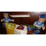 Mid-century fluorescent desk lamp, two soft toy monkeys and three banners