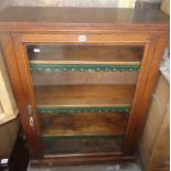 Edwardian oak bookcase with glazed door enclosing 5 shelves with leather trim, 33" wide