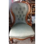 19th c. walnut balloon back nursing chair on carved cabriole legs and having button back upholstery