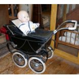 Triang coach built dolls pram with hood and cover, c. 1950's and an "OK" Kader plastic baby doll