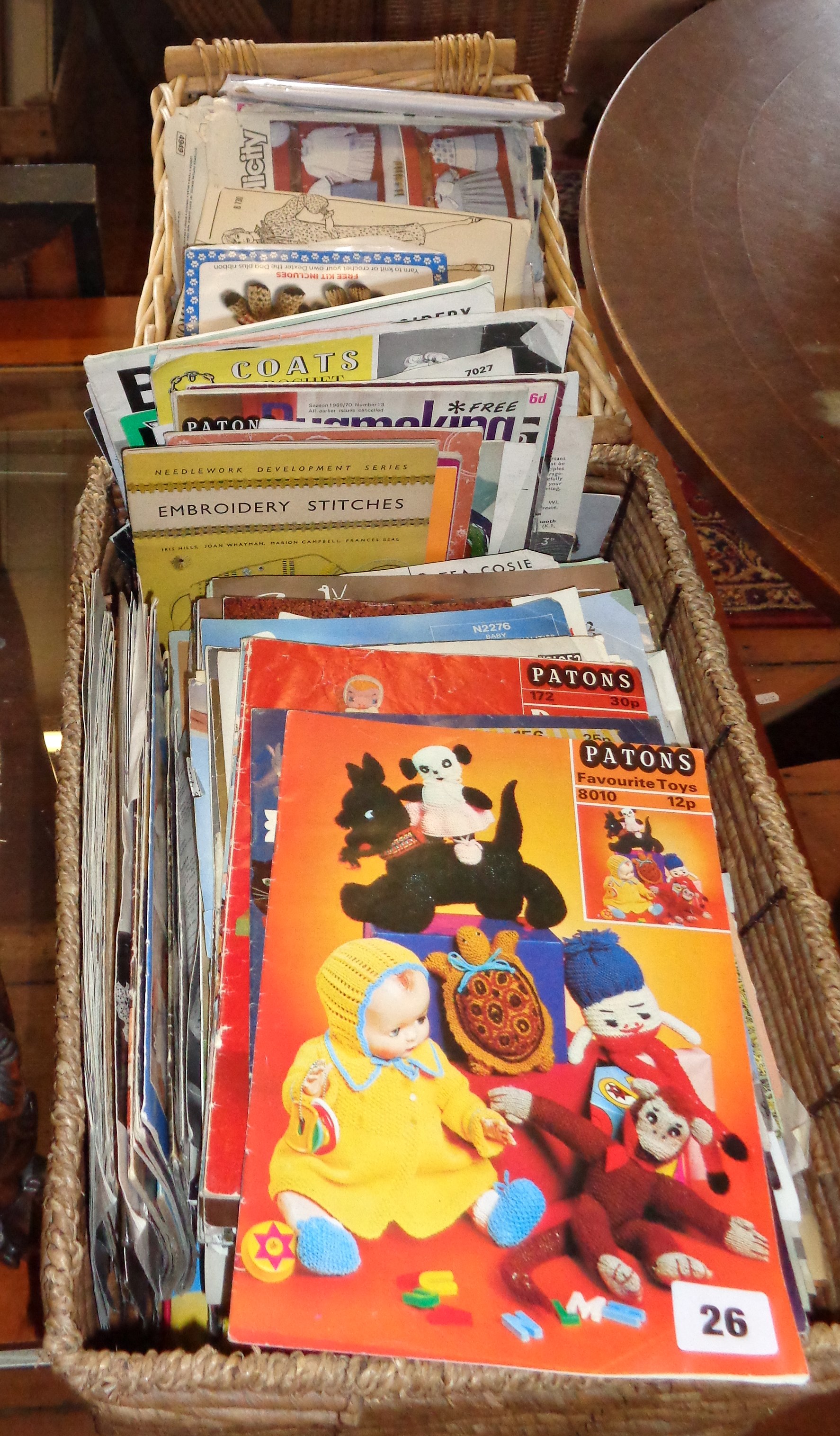 Two baskets of vintage dress, knitting and crochet patterns