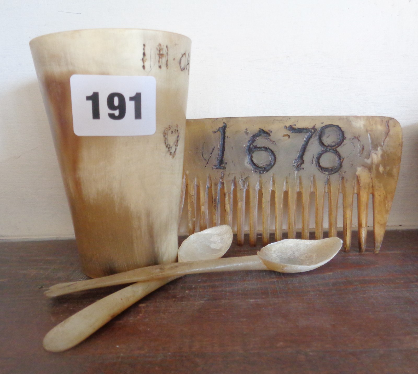 19th c. horn beaker, two spoons and a horn comb with 1678 date