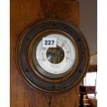 Edwardian aneroid barometer in carved wood frame, 8" diameter