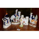 Four Victorian Staffordshire flatback figures and buildings together with a German? porcelain cherub