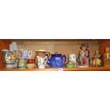 Shelf of pottery jugs and figures etc.