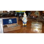 Painted cast iron clown money box, small Persian brass casket and a Wilkinson Sword safety razor,