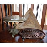 Two antique trivets, brass and copper, and another wooden set of 3 by David Mellor