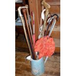 Collection of assorted walking sticks and vintage ladies umbrellas