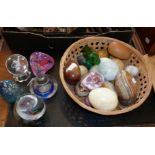 Five various glass paperweights and a collection of marble and polished stone eggs