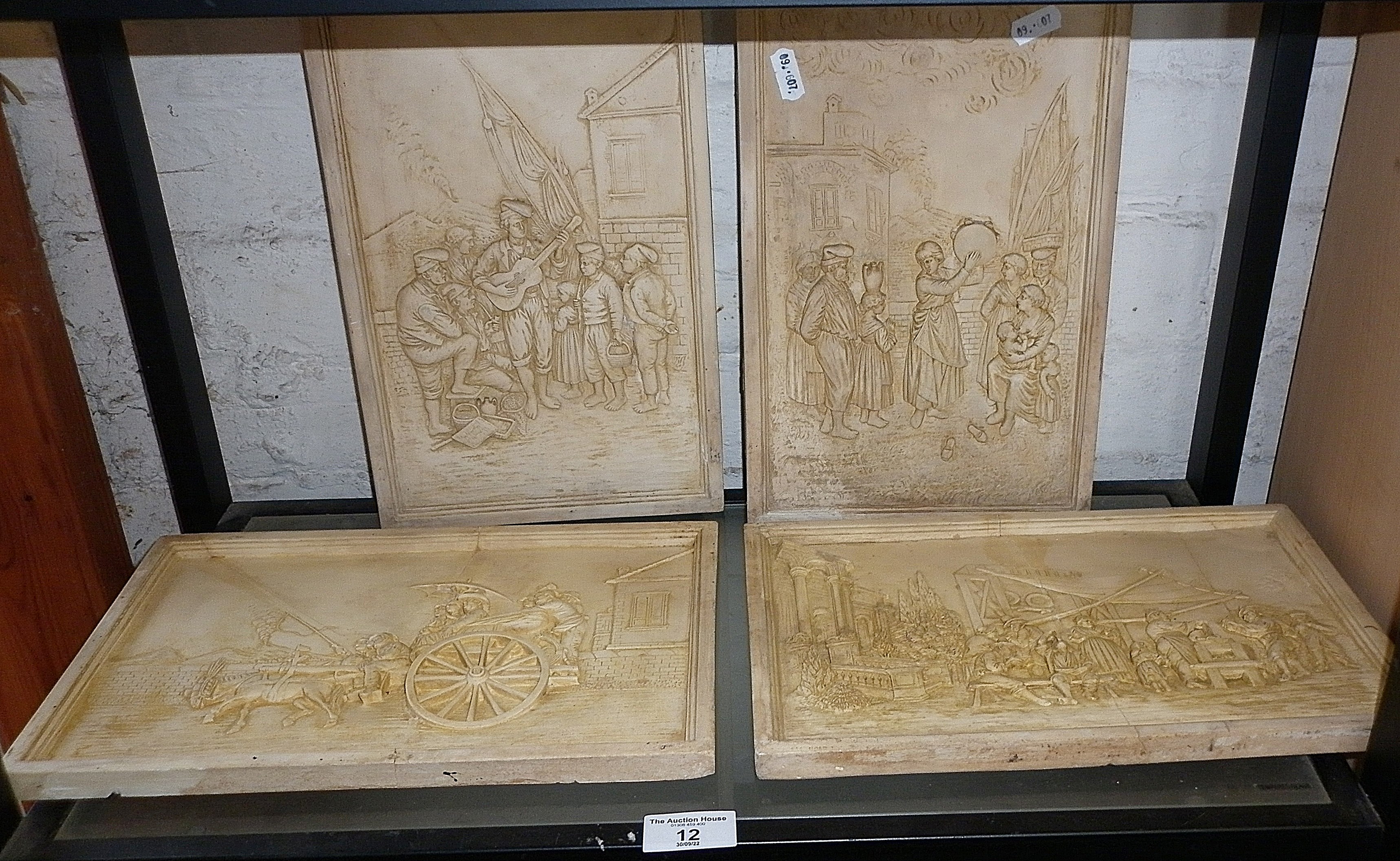 Four plaster relief plaques depicting rural Italian village life