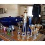 A Bohemian blue and gilt glass decanter set with four glasses having petal shaped feet together with