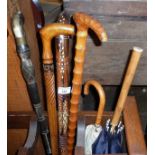 Four vintage walking sticks and two umbrellas