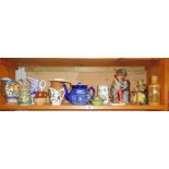 Shelf of pottery jugs and figures, etc.