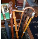 Seven various walking sticks and a gent's umbrella with horn handle and silver bands