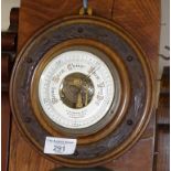 Edwardian aneroid barometer in carved wood frame, 8" diameter