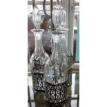 Silver plated tantalus of three cut glass decanters with hanging labels