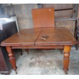 19th c. mahogany wind-out dining table on bold turned and fluted legs, extends to 6' with leaf and