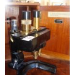 A W.Watson & Sons Ltd. binocular microscope, black enamel and brass with mahogany case