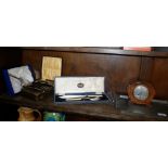 Arts & Crafts beaten pewter two-handled tray, 1930's oak mantle clock and assorted cutlery, cased