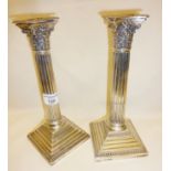 Pair of silver Corinthian column candlesticks, weighted, 25cm