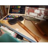 A fireman's axe with leather cover, artist's box with tubes of watercolour paint and a plasterer's