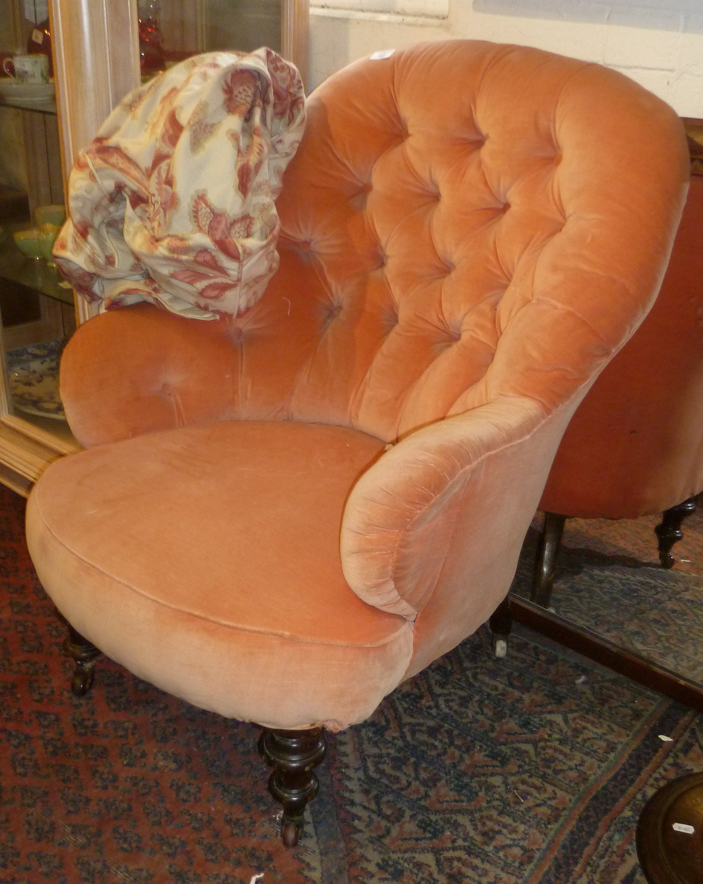 Victorian peach coloured velvet button backed armchair on turned mahogany legs