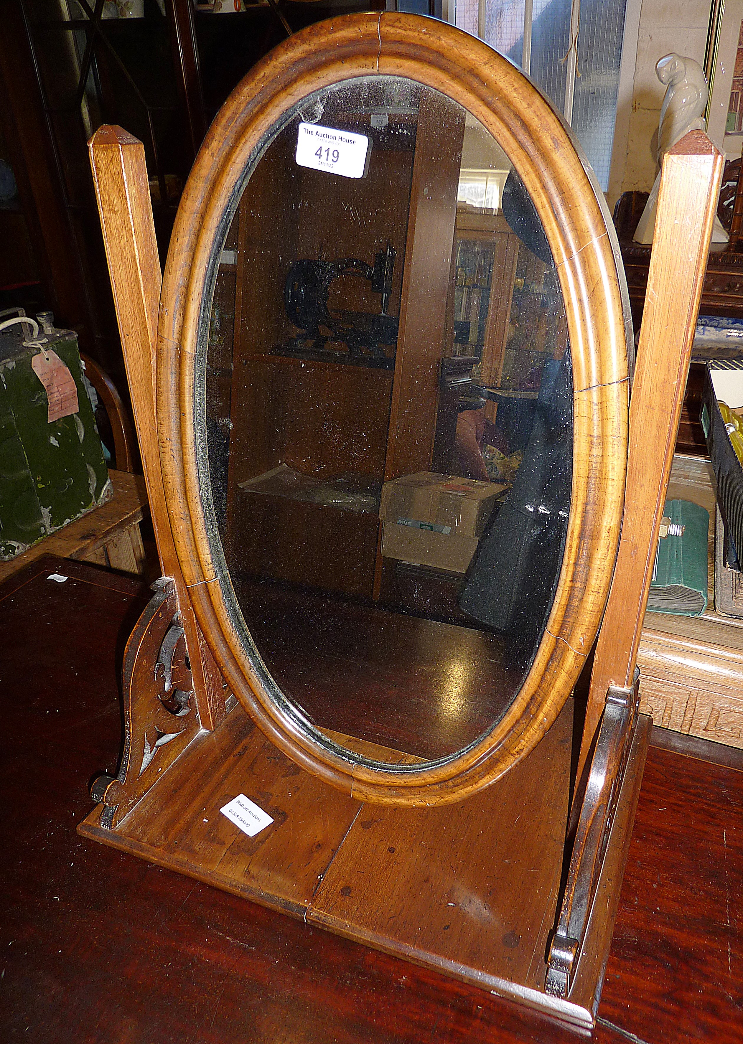 19th c. mahogany oval toilet mirror of carved supports