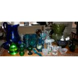 Assorted glassware including green glass eyebaths, blue glass water jug etc