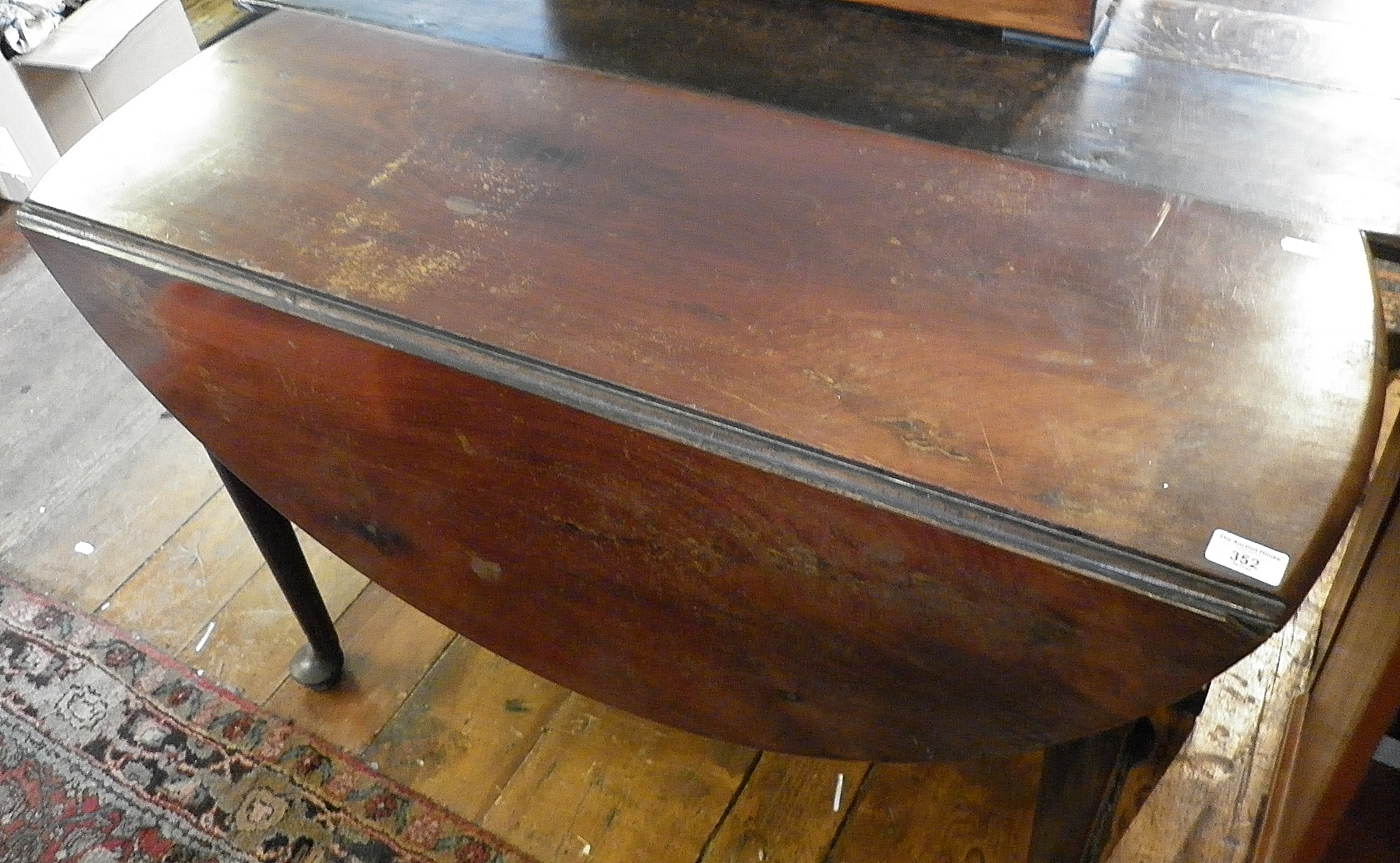 Georgian mahogany pad foot oval drop leaf dining table