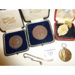 WW2 medal, 1920s Christs Hospital bronze sports medallions, 1900 convention badge, and a golfing